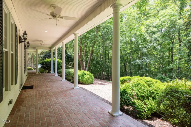 an empty room with wooden floor and a fireplace