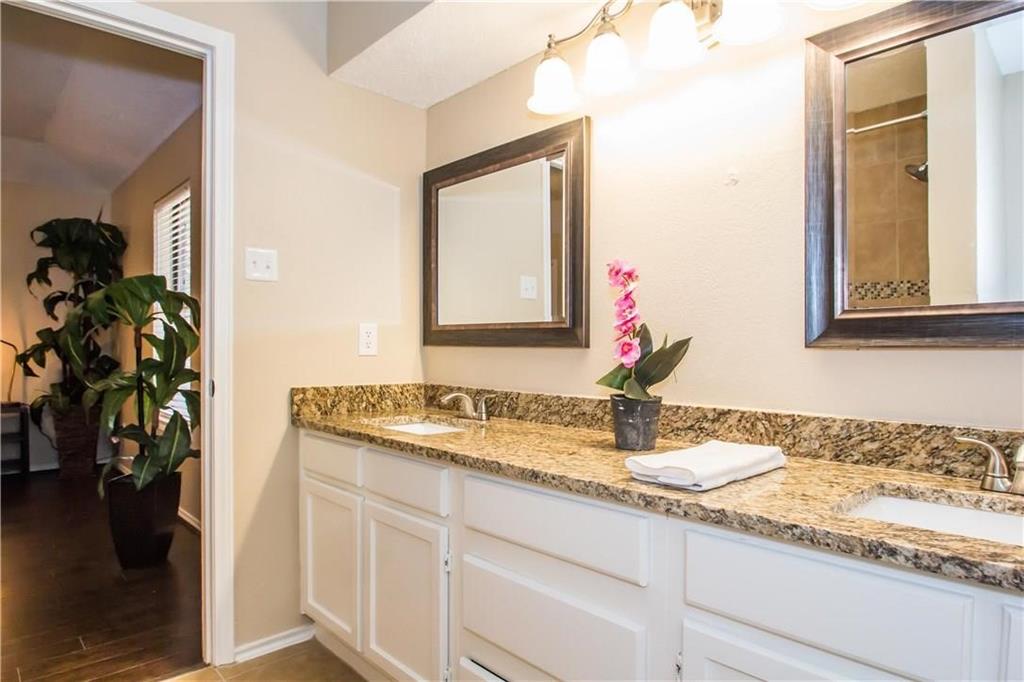 2405 Cranberry Lane Euless, TX 76039 - Photo 16 of 19 Bathroom featuring double vanity, a shower, and light wood-style flooring