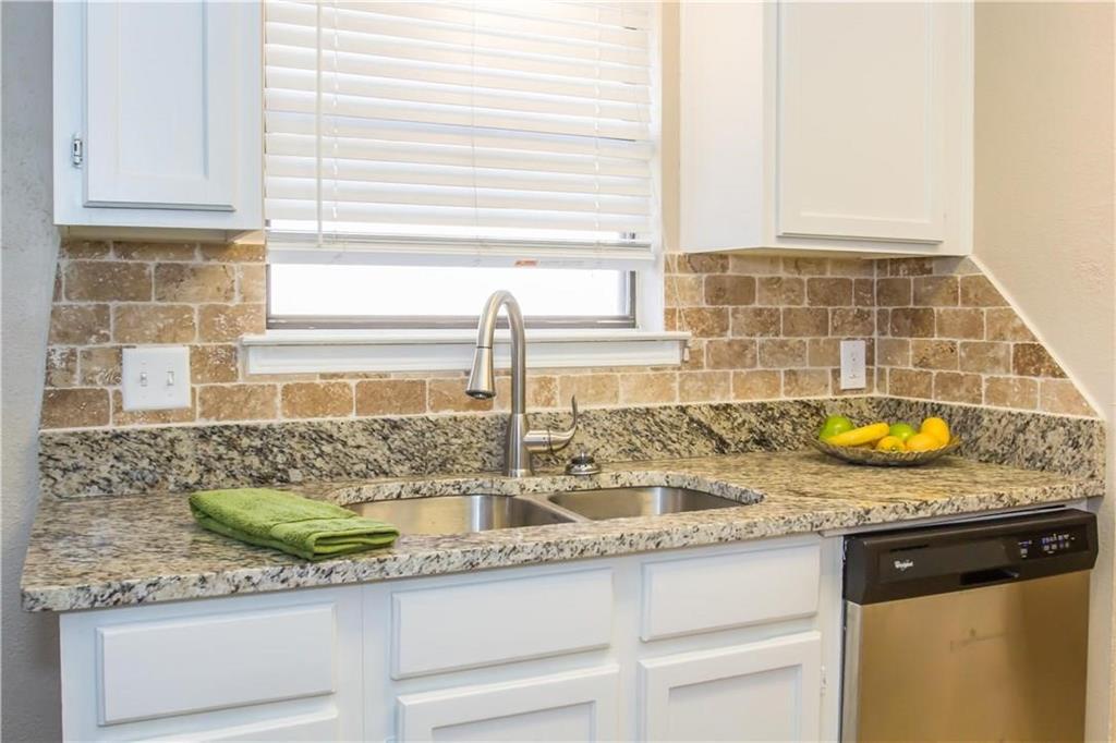 2405 Cranberry Lane Euless, TX 76039 - Photo 7 of 19 Kitchen with dishwasher, light stone countertops, white cabinets, and decorative backsplash