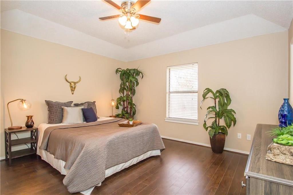2405 Cranberry Lane Euless, TX 76039 - Photo 10 of 19 Bedroom with dark wood-type flooring, ceiling fan, and lofted ceiling