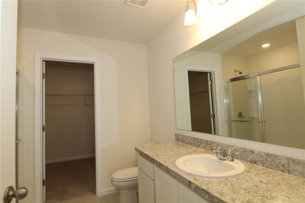 2233 Litchfield Loop DeLand, FL 32720 - Photo 14 of 20 a bathroom with a granite countertop sink toilet and shower