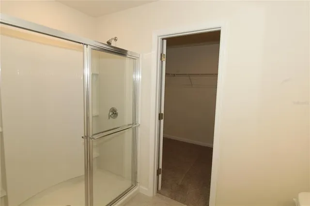 a bathroom with a glass shower door