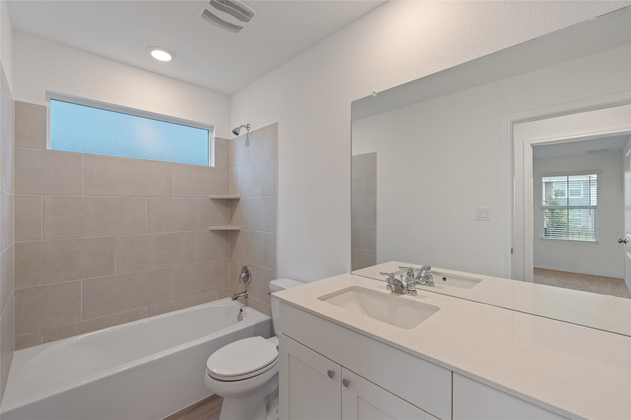 115 Parsons Kyle, TX 78640 - Photo 14 of 18 A well-appointed bathroom with a spacious vanity and full-sized mirror awaits.