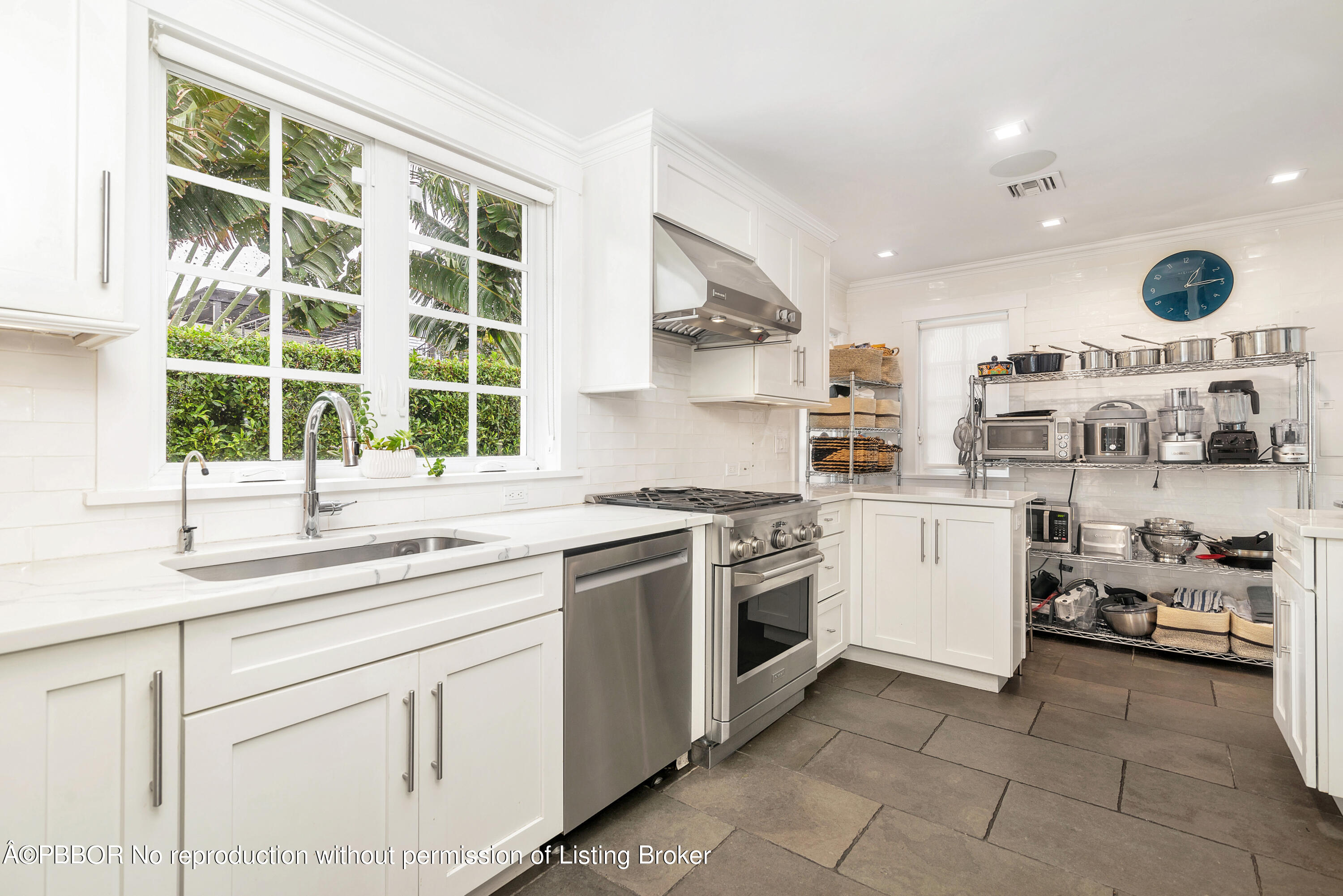 231 Sunset Road West Palm Beach, FL 33401 - Photo 10 of 22 a kitchen with a sink and a stove top oven