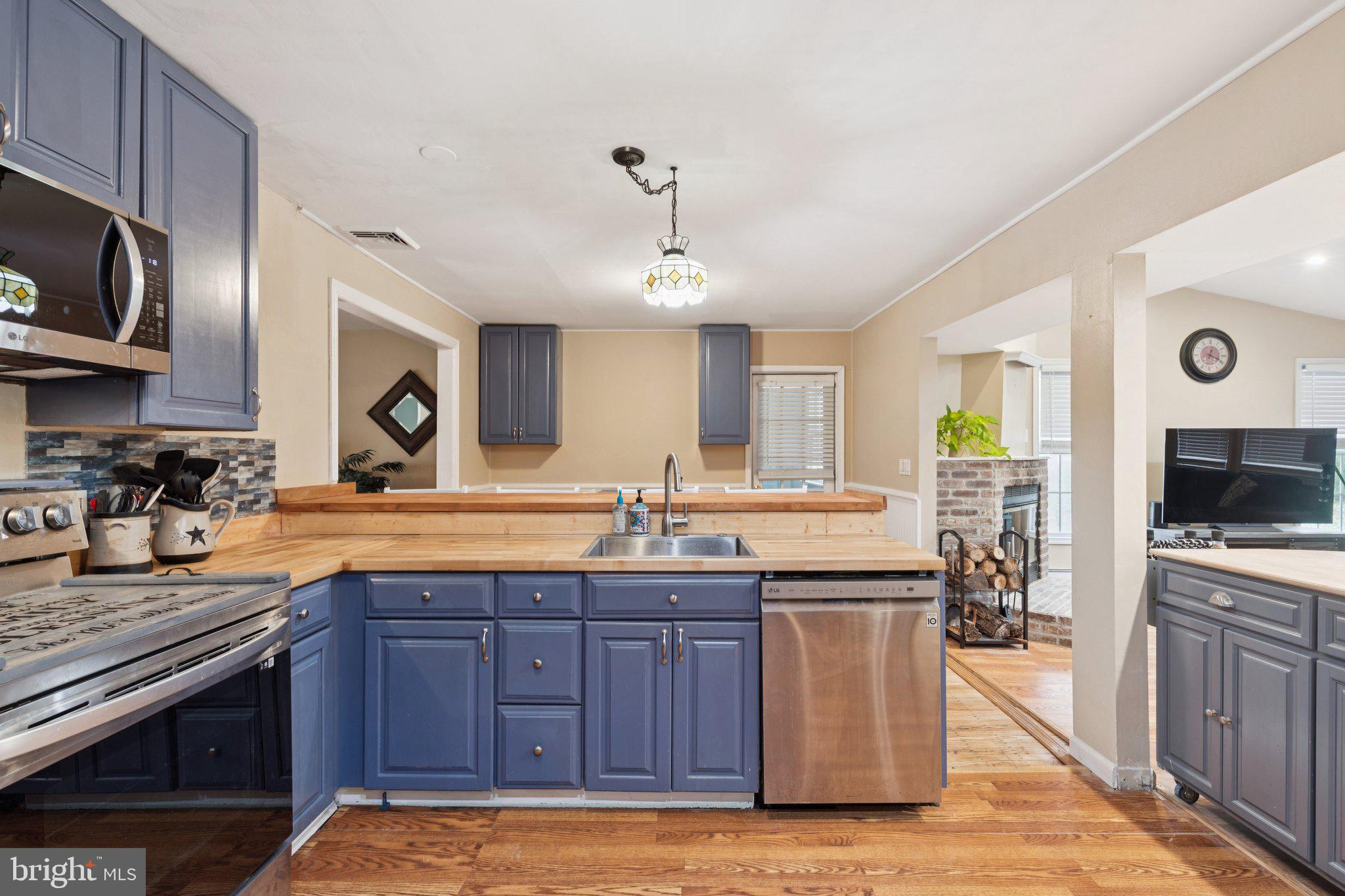 35 Buckwalter Road Eagleville, PA 19403 - Photo 22 of 54 a kitchen with stainless steel appliances granite countertop a stove a sink dishwasher and a microwave oven with wooden cabinets