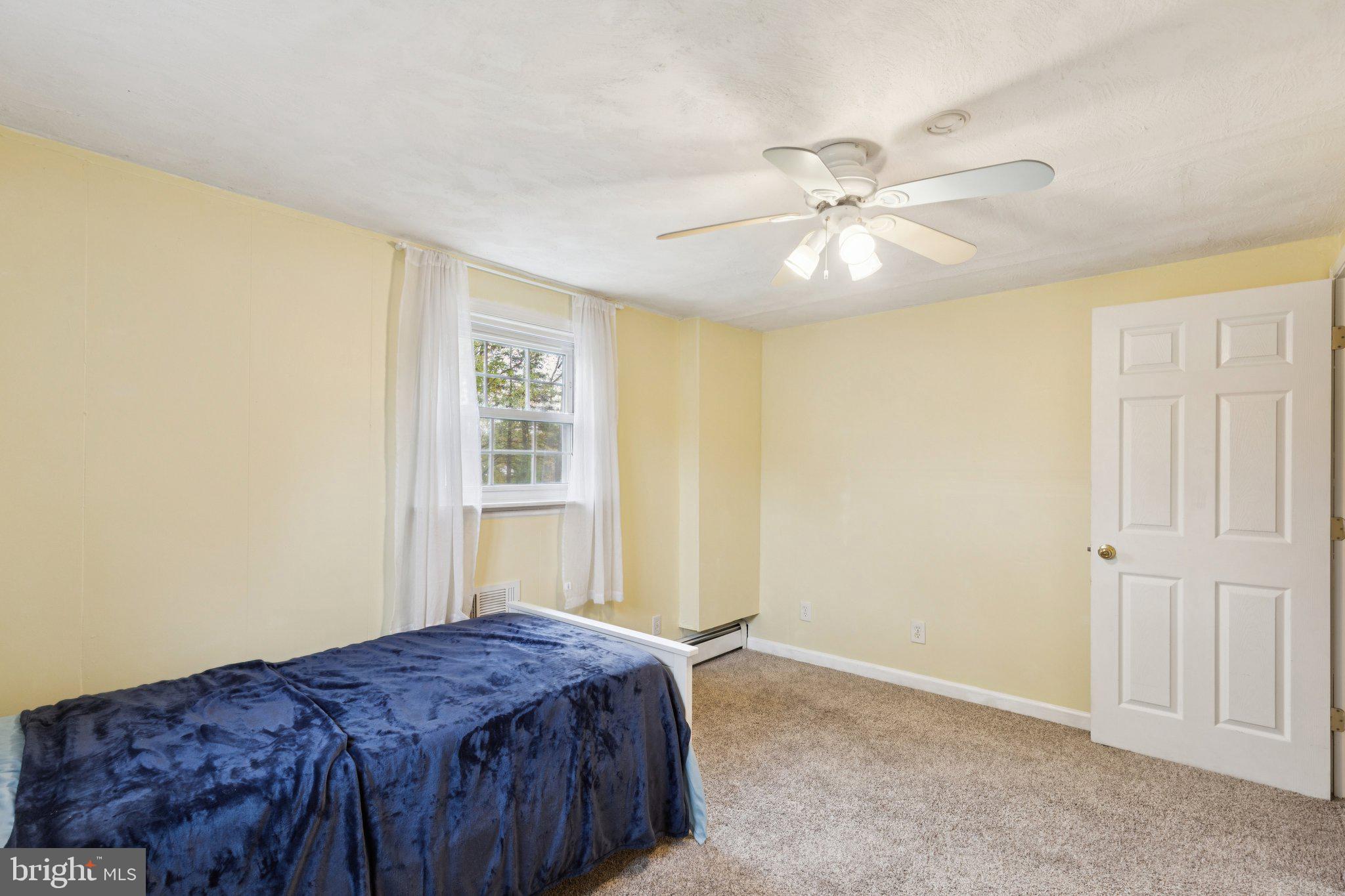 35 Buckwalter Road Eagleville, PA 19403 - Photo 45 of 54 a bedroom with a bed and a chandelier
