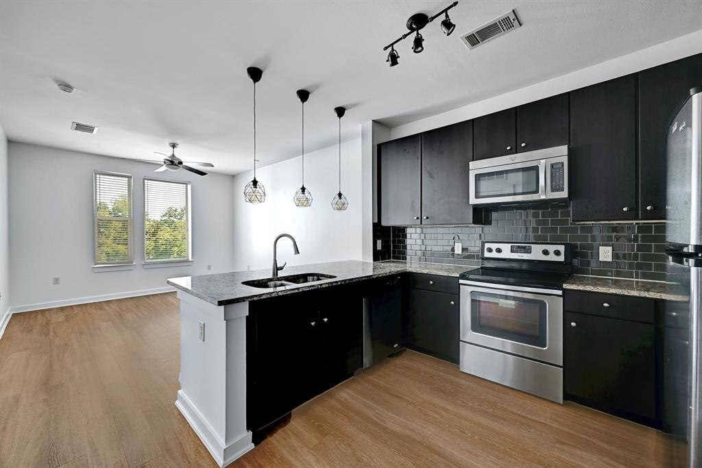 a kitchen with a sink stove and microwave