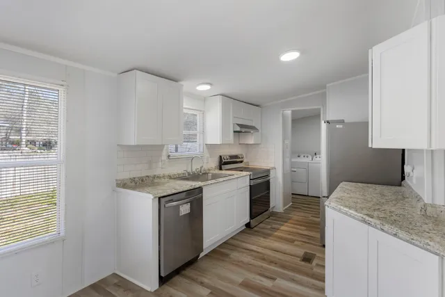 a kitchen with a sink stove and refrigerator