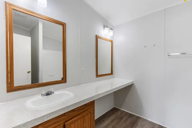 a bathroom with a sink a mirror and a window