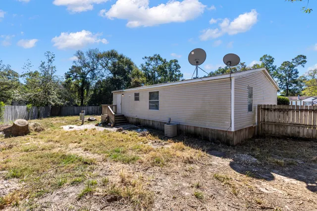 a view of a backyard with large trees