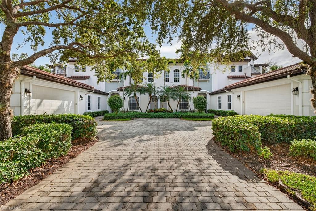 Mediterranean / spanish house with decorative driveway, stucco siding, and a tiled roof