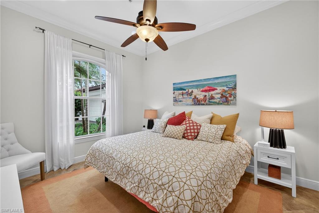 28540 Calabria Court, Unit 101 Naples, FL 34110 - Photo 21 of 41 Bedroom featuring a ceiling fan and crown molding