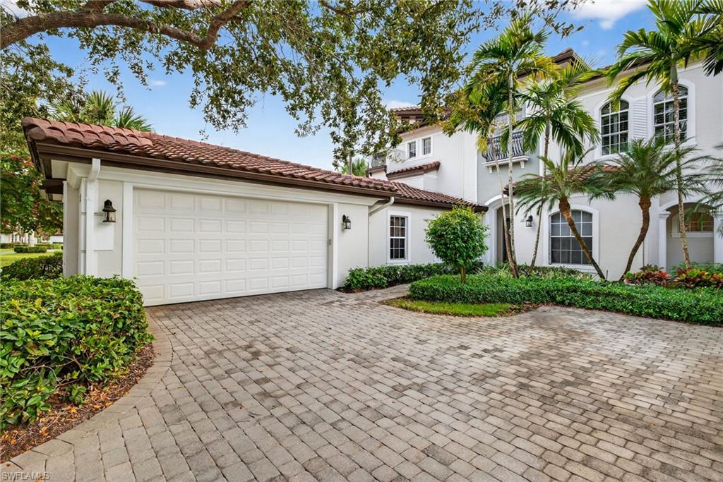 28540 Calabria Court, Unit 101 Naples, FL 34110 - Photo 27 of 41 Mediterranean / spanish home featuring stucco siding, decorative driveway, a garage, and a tile roof