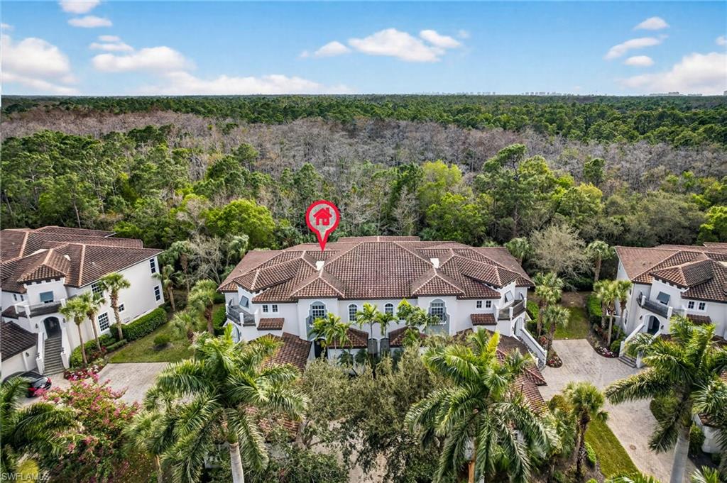 28540 Calabria Court, Unit 101 Naples, FL 34110 - Photo 28 of 41 Drone / aerial view of a heavily wooded area