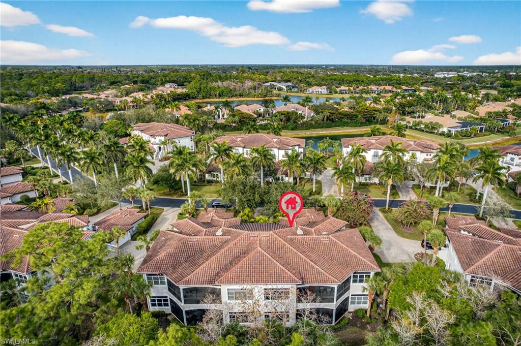 28540 Calabria Court, Unit 101 Naples, FL 34110 - Photo 30 of 41 Aerial view of property and surrounding area featuring nearby suburban area
