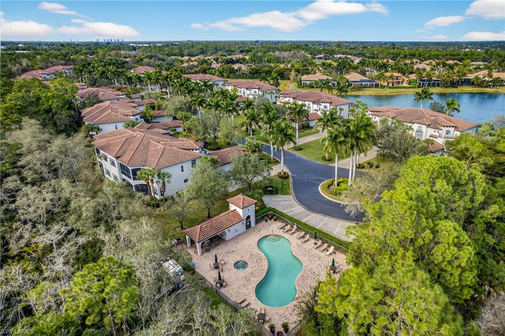 28540 Calabria Court, Unit 101 Naples, FL 34110 - Photo 31 of 41 Aerial view of residential area featuring a large body of water