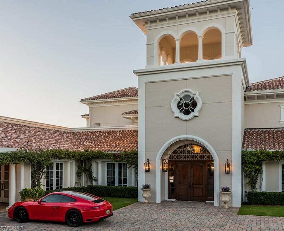 28540 Calabria Court, Unit 101 Naples, FL 34110 - Photo 34 of 41 Doorway to property featuring stucco siding and a tile roof