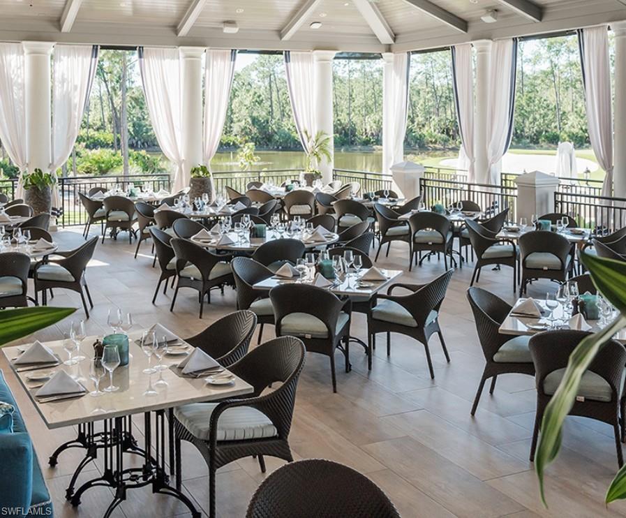 28540 Calabria Court, Unit 101 Naples, FL 34110 - Photo 35 of 41 Sunroom / solarium with healthy amount of natural light, beamed ceiling, and view of scattered trees