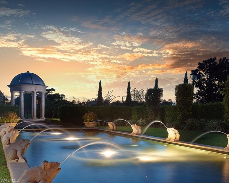 28540 Calabria Court, Unit 101 Naples, FL 34110 - Photo 38 of 41 Pool at dusk featuring a patio