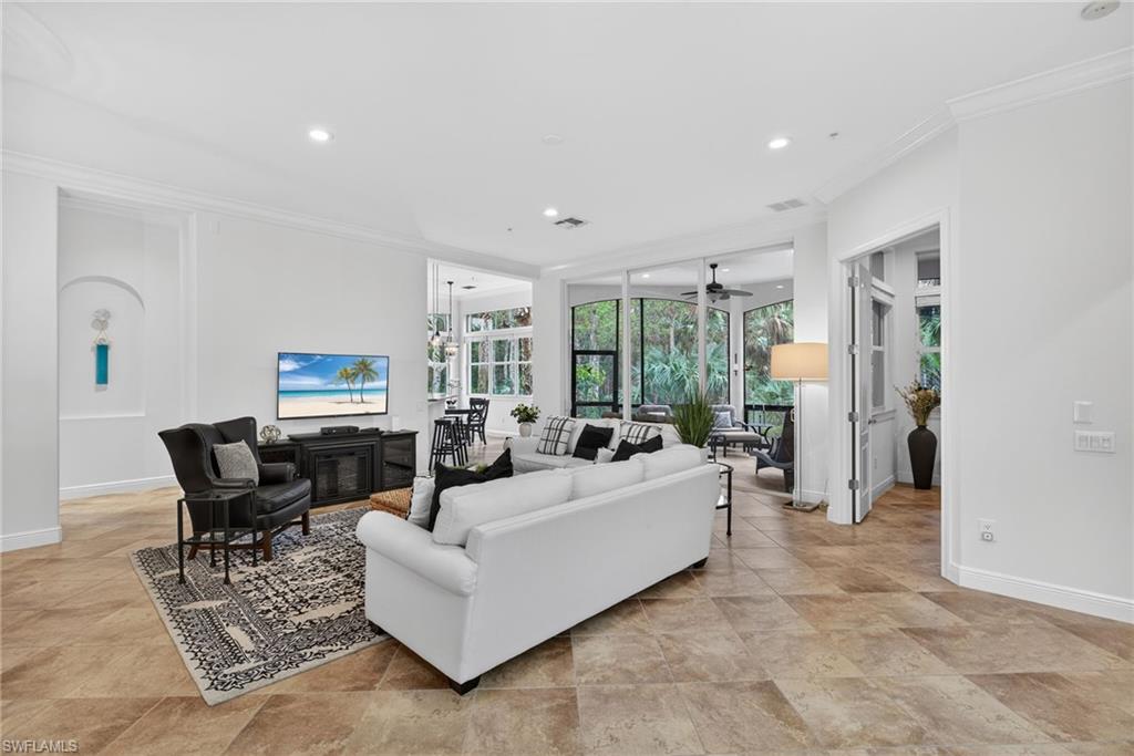 28540 Calabria Court, Unit 101 Naples, FL 34110 - Photo 4 of 41 Living area featuring crown molding, recessed lighting, and ceiling fan