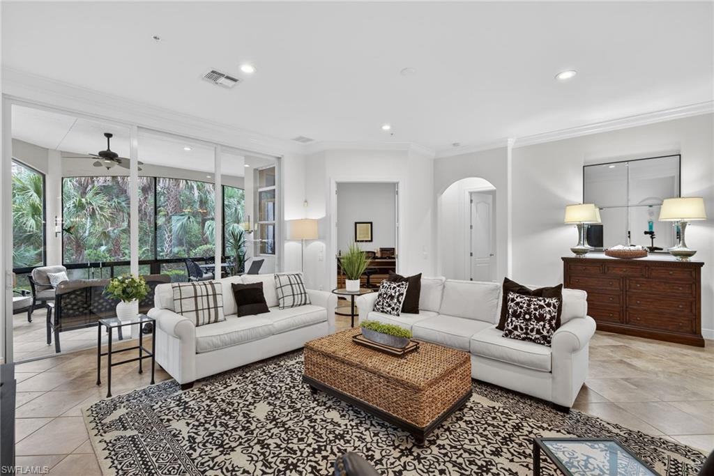 28540 Calabria Court, Unit 101 Naples, FL 34110 - Photo 5 of 41 Living room with crown molding, recessed lighting, a ceiling fan, arched walkways, and light tile patterned flooring