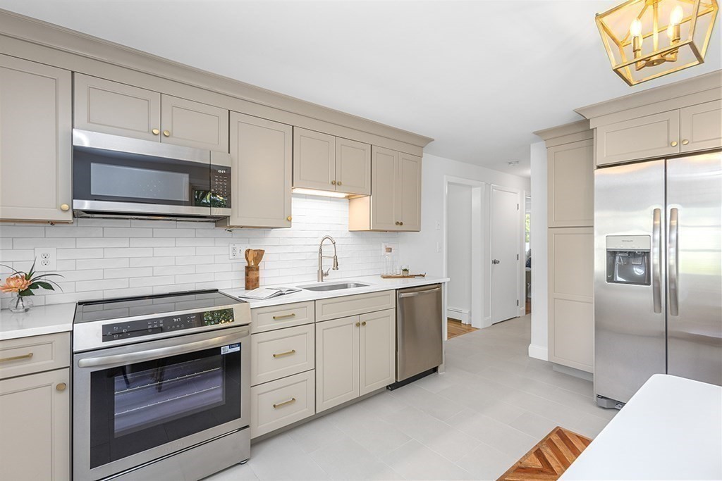 117 Oak Ridge Drive Ayer, MA 01432 - Photo 10 of 26 a kitchen with cabinets stainless steel appliances and a window