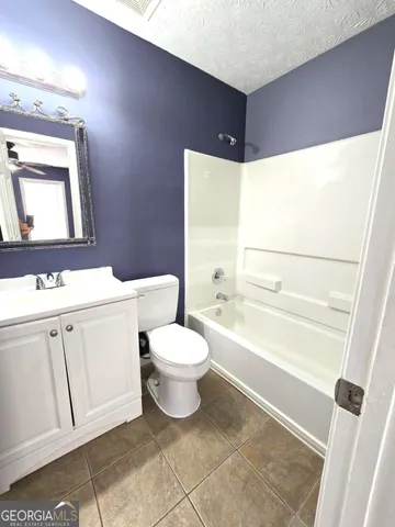 a bathroom with a toilet sink and a bathtub
