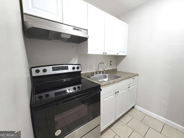 a kitchen with a stove and a microwave