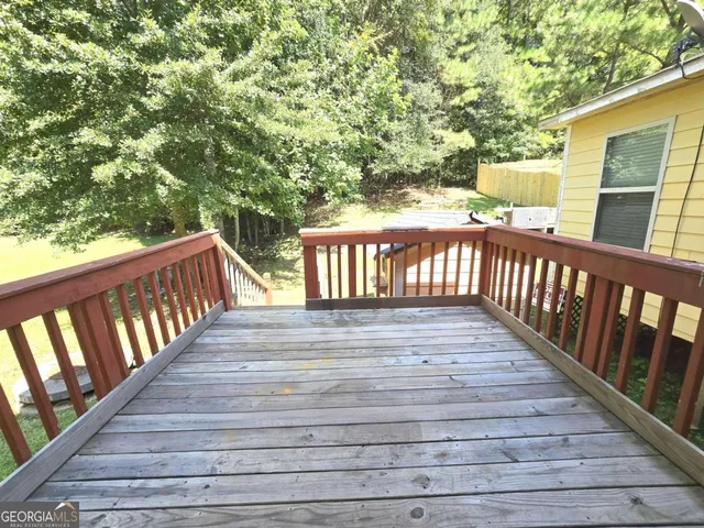 a view of deck with wooden floor and fence
