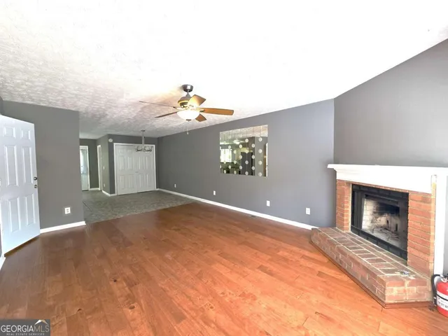 a view of an empty room with a fireplace