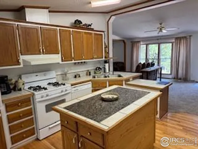 a kitchen with a stove a sink and a wooden cabinets