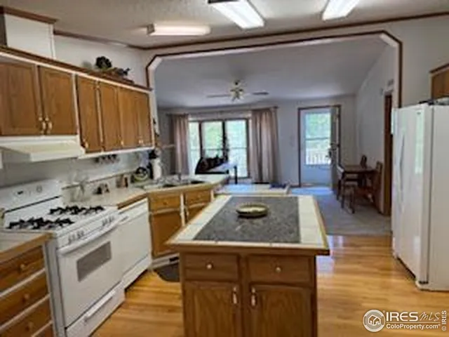 a kitchen with sink a stove and refrigerator