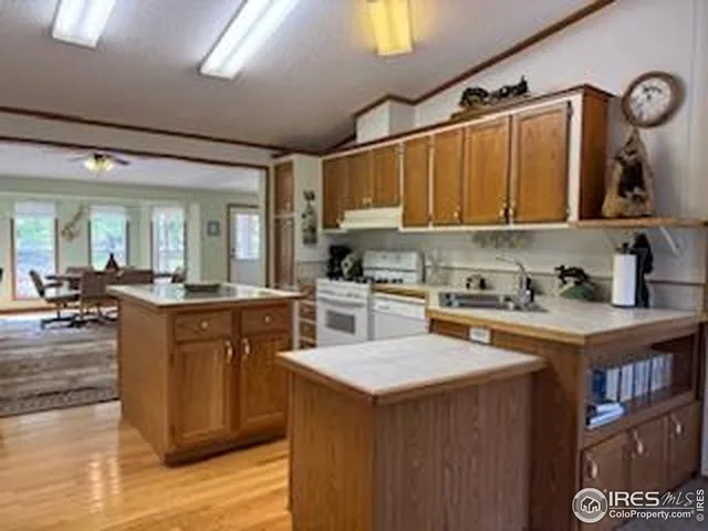 a kitchen with cabinets a sink and appliances
