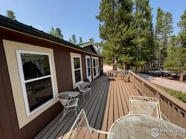 a view of balcony with wooden floor and outdoor seating