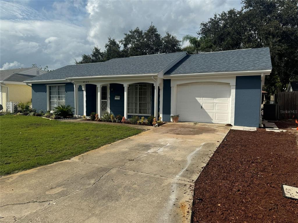 4025 Grayton Drive New Port Richey, FL 34652 - Photo 1 of 33 a front view of a house with a yard and trees