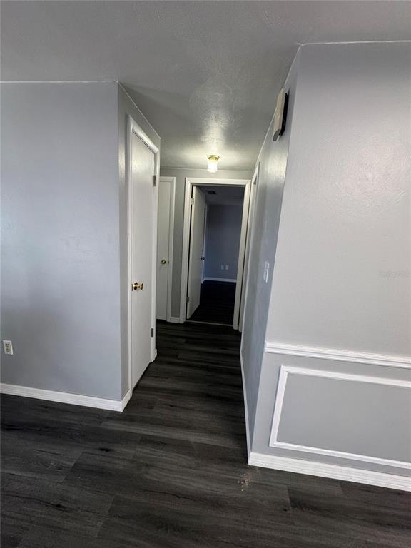 4025 Grayton Drive New Port Richey, FL 34652 - Photo 11 of 33 a view of a hallway with wooden floor and staircase