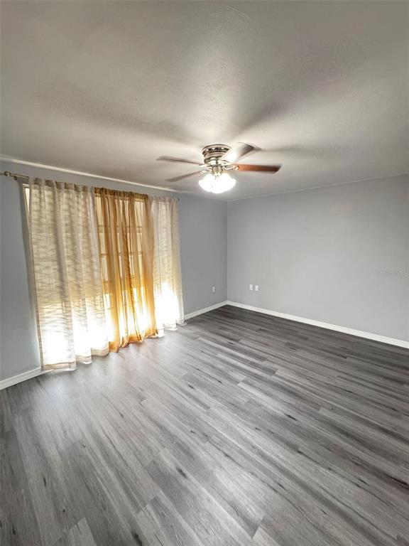4025 Grayton Drive New Port Richey, FL 34652 - Photo 12 of 33 a view of an empty room with wooden floor and a window