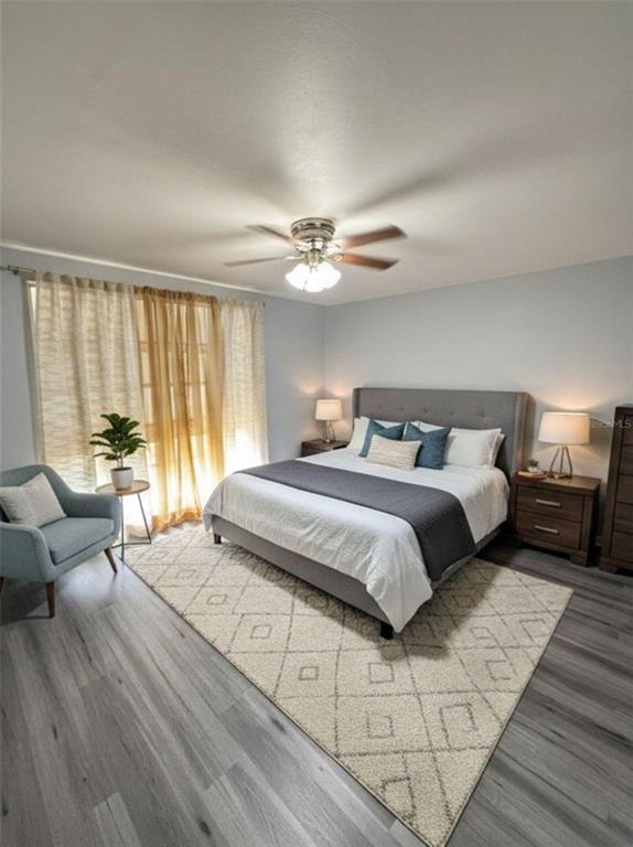 4025 Grayton Drive New Port Richey, FL 34652 - Photo 14 of 33 a bedroom with a large bed and a chandelier