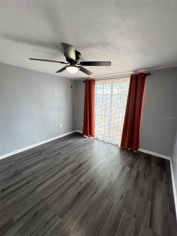 4025 Grayton Drive New Port Richey, FL 34652 - Photo 15 of 33 an empty room with wooden floor and windows