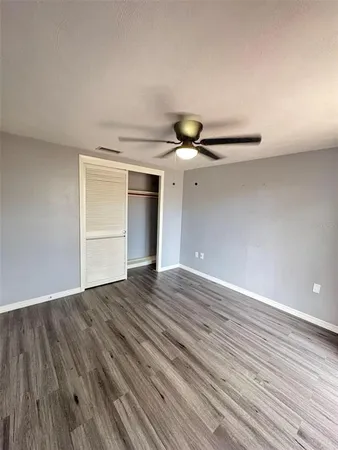 a view of an empty room and wooden floor
