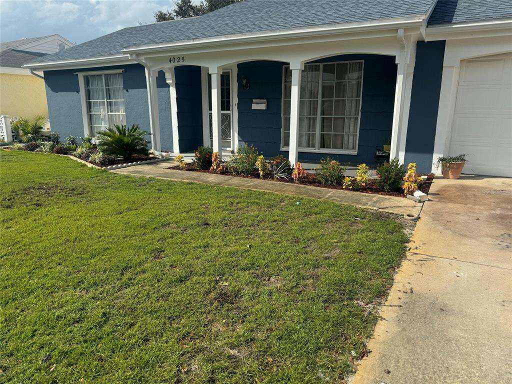 4025 Grayton Drive New Port Richey, FL 34652 - Photo 2 of 33 a front view of a house with garden