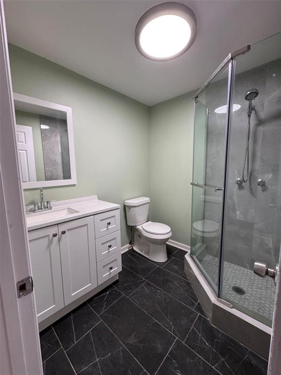 4025 Grayton Drive New Port Richey, FL 34652 - Photo 23 of 33 a bathroom with a double vanity sink toilet and shower