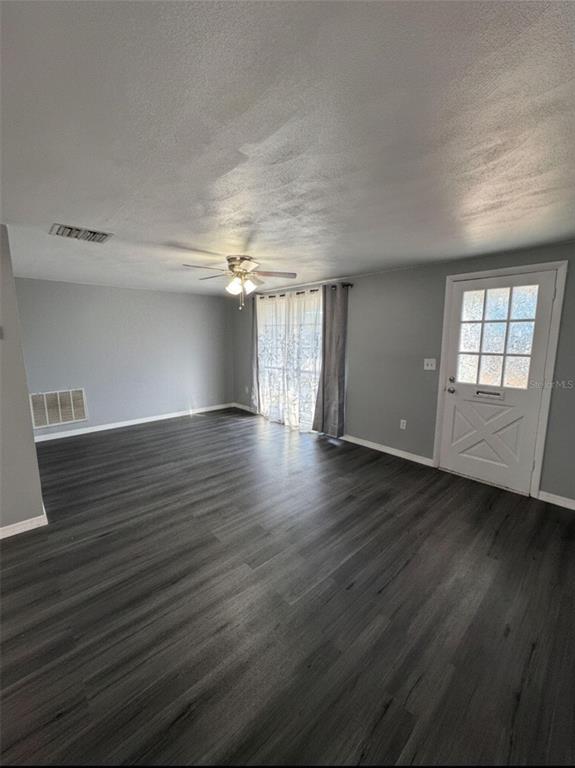 4025 Grayton Drive New Port Richey, FL 34652 - Photo 3 of 33 an empty room with wooden floor and windows