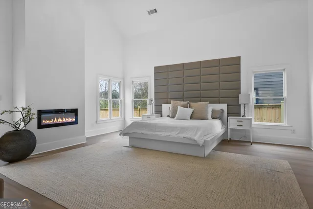 a spacious bedroom with a bed and a couch