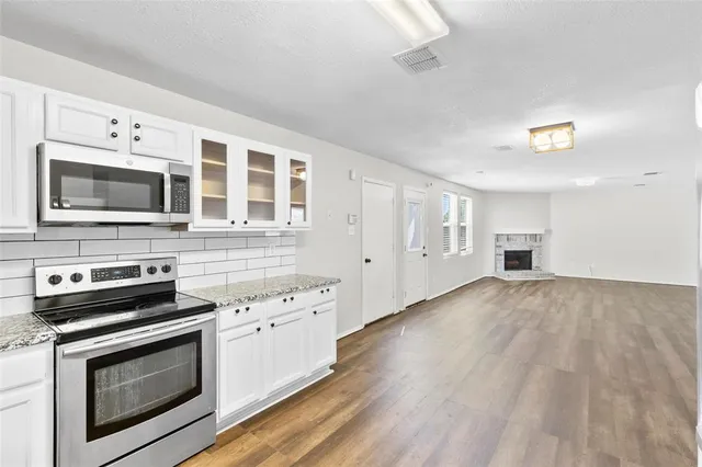 a view of kitchen and hall with wooden floor