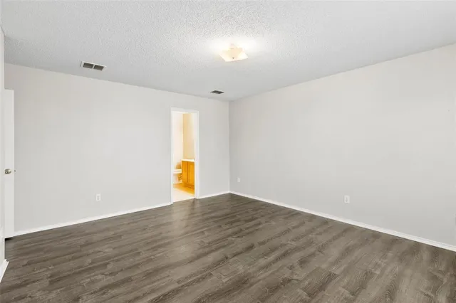 a bathroom with a bathtub shower sink mirror and toilet
