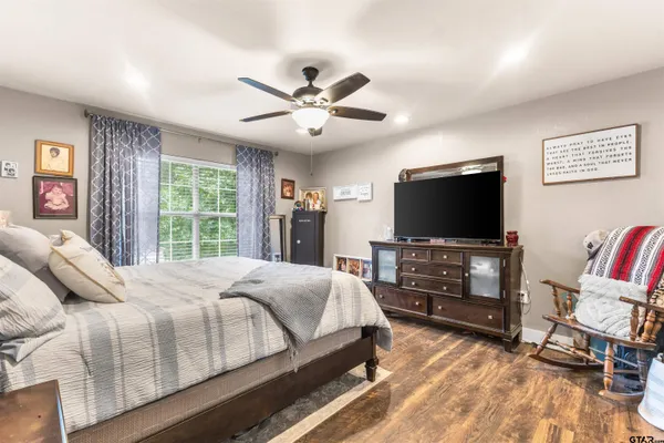 a bedroom with a bed and a flat screen tv