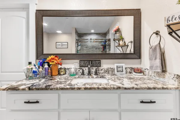 a bathroom with sink and mirror