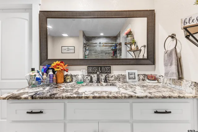 a bathroom with sink and mirror