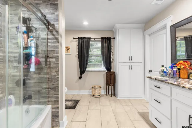 a bathroom with a bathtub and shower